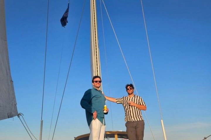 a group of men riding on the back of a boat