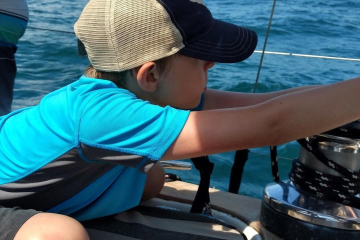 a kid enjoying the view from the boat