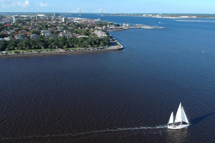 a large body of water with a city in the background