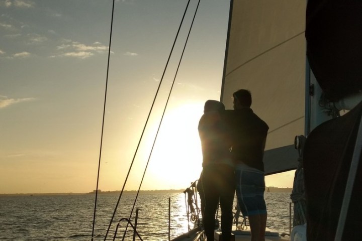 a man standing next to a body of water
