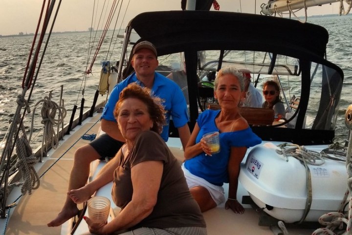 Vicki Genfan et al. sitting on a boat in the water