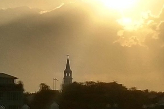 a castle with a sunset in the background