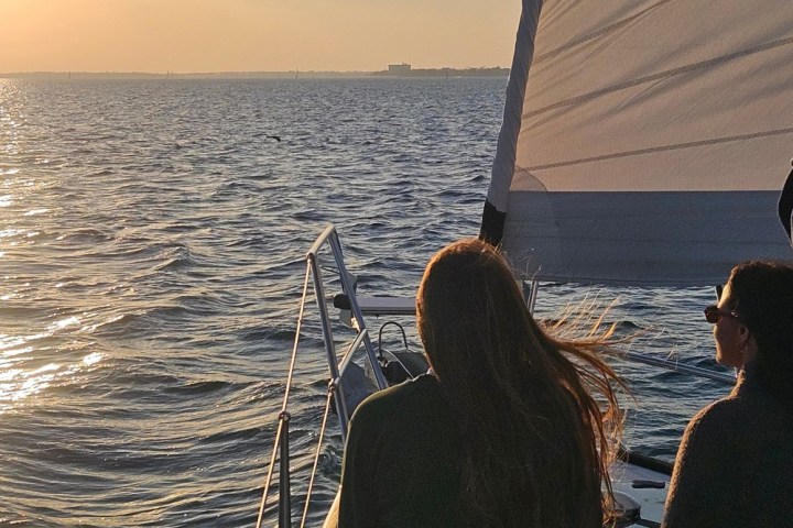 a person sitting next to a body of water