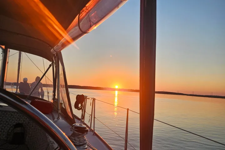 Sunset view from a sailboat, calm water and warm colors.