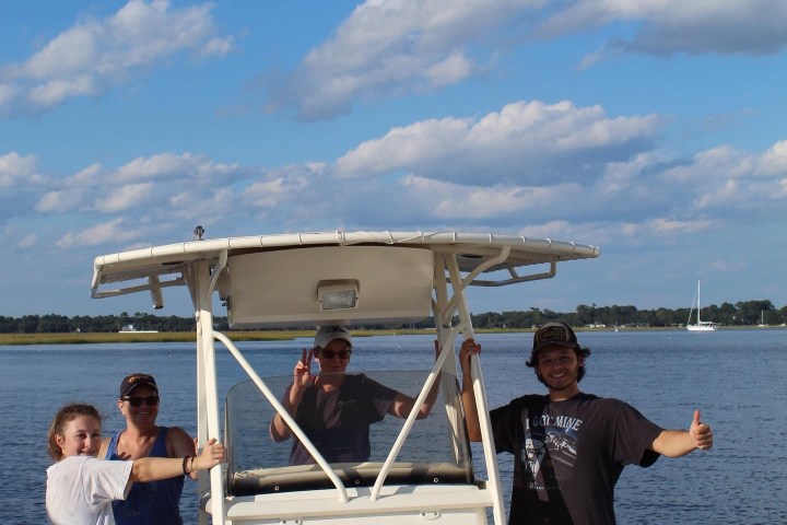 a group of people in a boat on a body of water