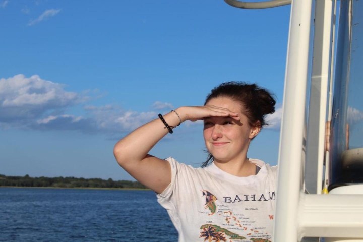 a man standing in front of a body of water