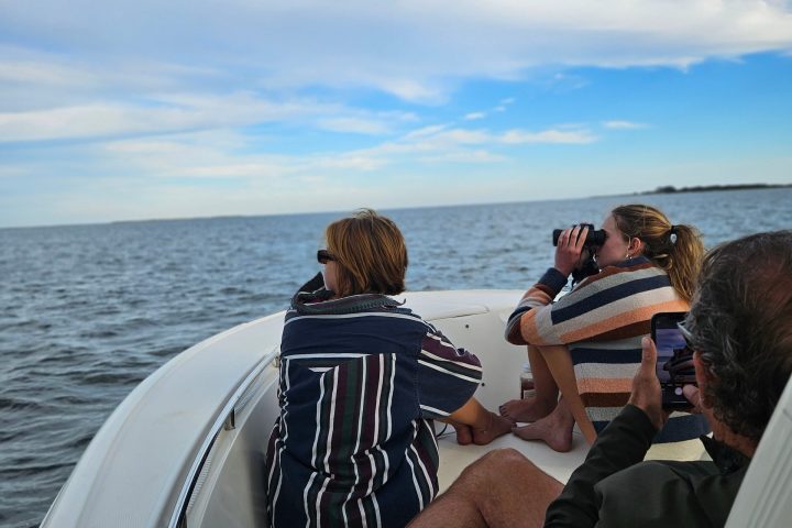 a group of people in a boat on a body of water