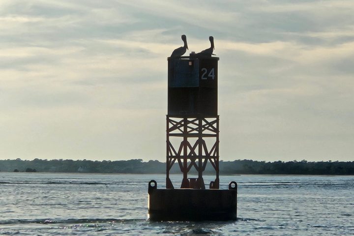 a clock tower in the middle of a body of water