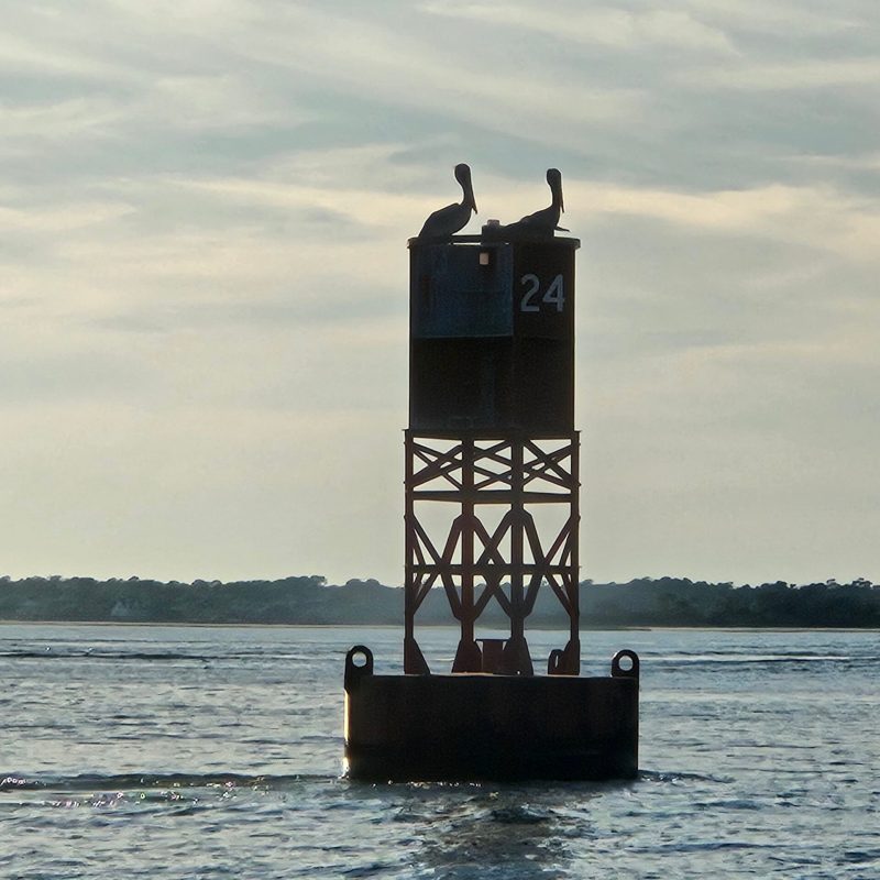 a clock tower in the middle of a body of water