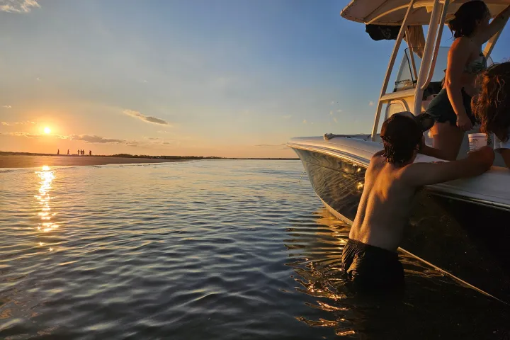 a man standing next to a body of water